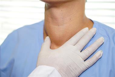 Doctor checking a patient's thyroid
