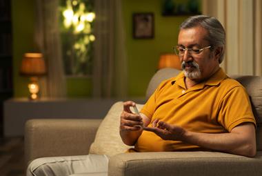 South Asian man undertaking a fingerprick blood test 