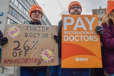 Junior doctors holding pay restoration sign during strikes in February this year