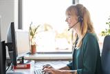 Woman on a phone call while using a computer