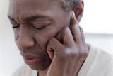 Woman holding her ear in pain