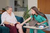 Clinician examining a woman's leg